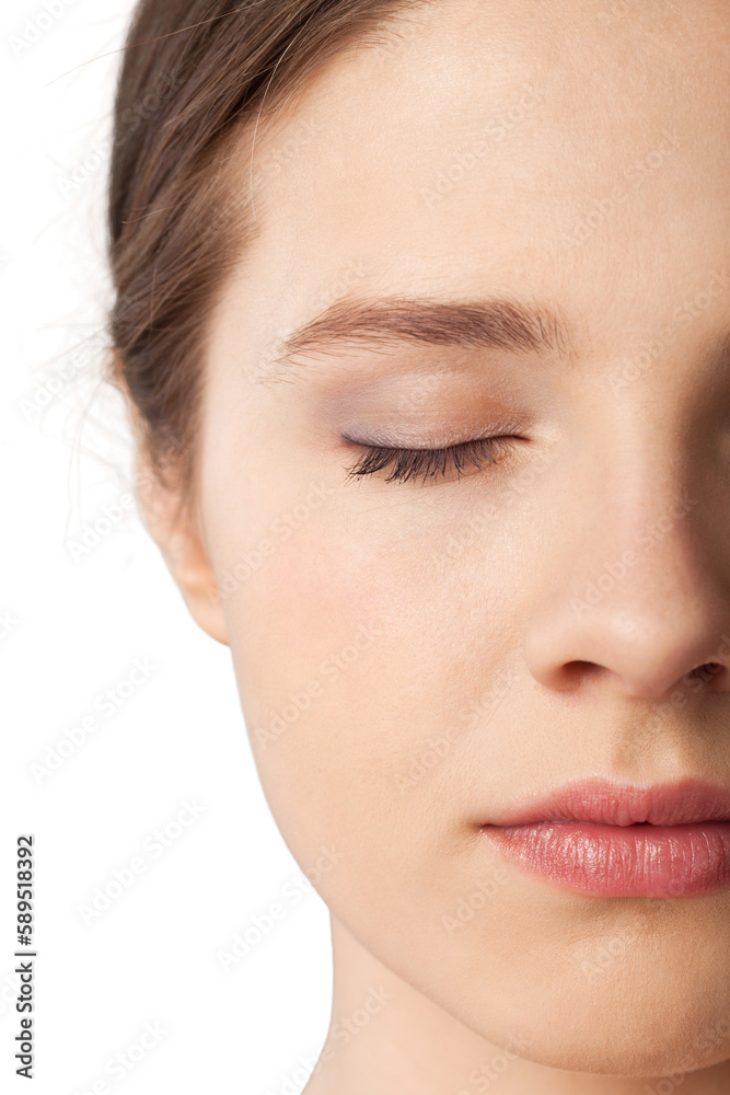 Close up portrait of pretty young woman with eye closed on a white background Close up portrait of pretty young woman with eye closed on a white background