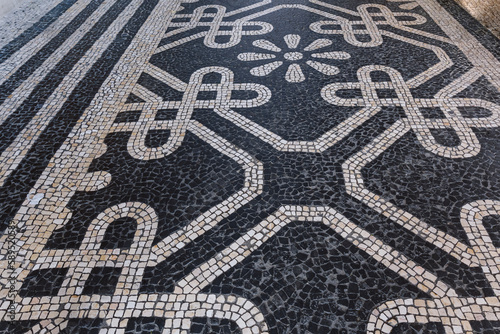 Tile brick floor in Lisbon, Portugal. Traditional old type mosaic on the sidewalk or pavement in the city