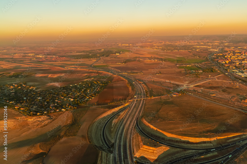 Aerial of Highway and fields close to Madrid airport, spain by sunset