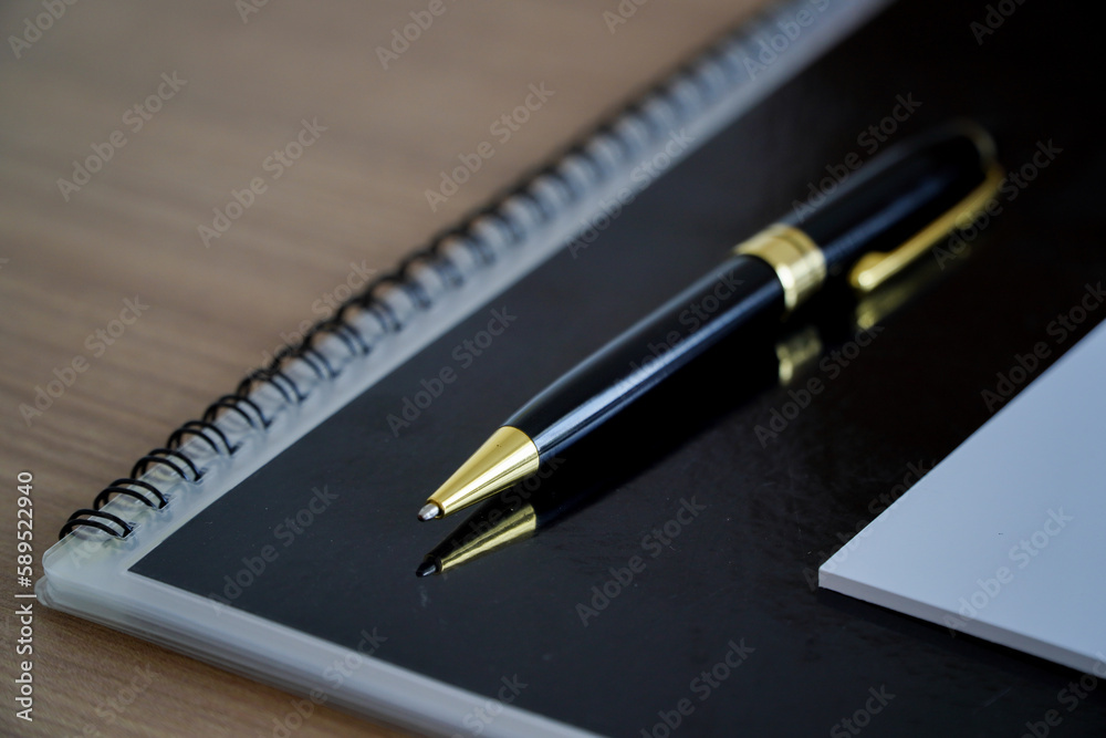 Notebook and pen on wooden table. Business concept. top view with copy space, copy space for office work text. Notebook and pen on wooden table. Business concept. top view with copy space, copy space for office work text.