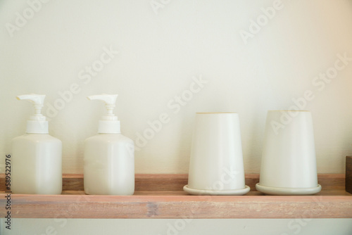 White bottle of shampoo and conditioner on shelf decoration in bathroom interior - Vintage Light Filter © Apicha