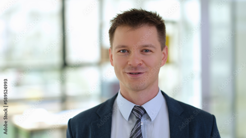 Successful businessman in suit with tie in office portrait. Business career growth concept Successful businessman in suit with tie in office portrait. Business career growth concept