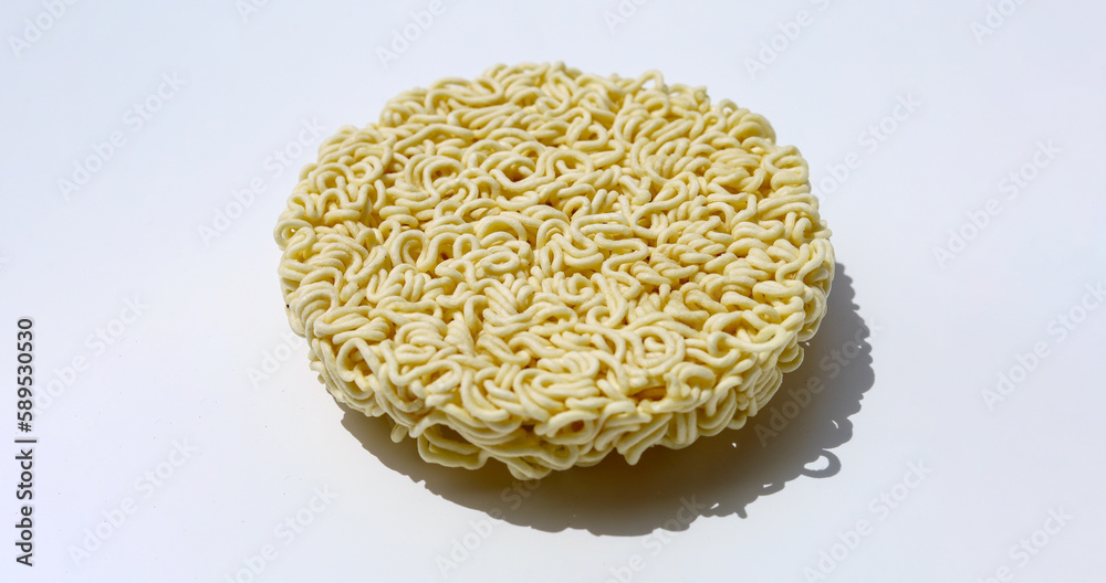 Raw instant noodles on white background - round instant noodles