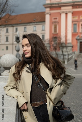 Young beatiful woman portrait in the historical city centre of Ljubljana in trendy outfit