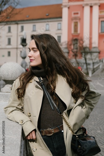 Young beatiful woman portrait in the historical city centre of Ljubljana in trendy outfit