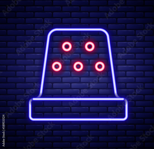 Glowing neon line Thimble for sewing icon isolated on brick wall background. Colorful outline concept. Vector