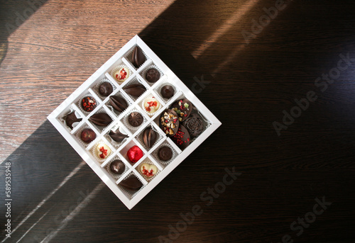 A box of handmade chocolates of different colors