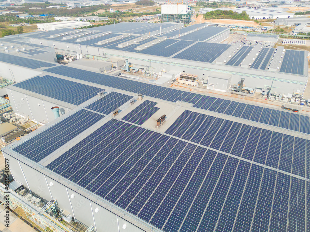 Aerial view of solar panels or solar cells on the roof of factory ...