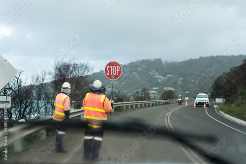 stop go workers on a stretch of highway, working on a cold, gloomy day. photo