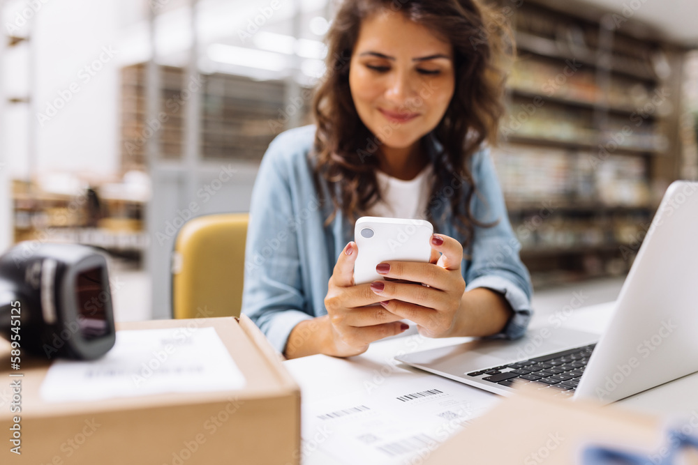 Online store manager sending a text message on a smartphone Online store manager sending a text message on a smartphone