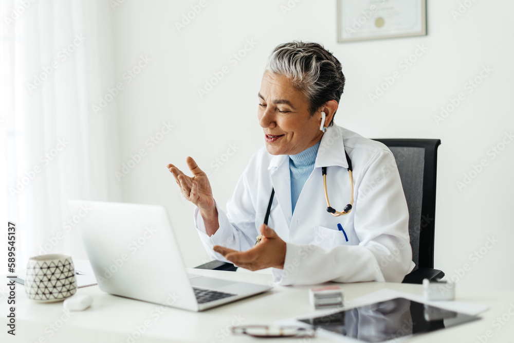Mature female professor giving an online lecture on a video call Mature female professor giving an online lecture on a video call
