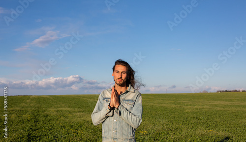 Long hair man in green meadow
