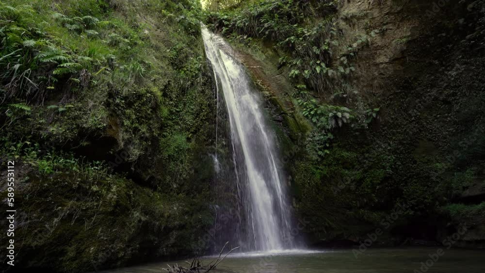 Beautiful waterfall inside a cavern with a pool. North Island, New Zealand Beautiful waterfall inside a cavern with a pool. North Island, New Zealand
