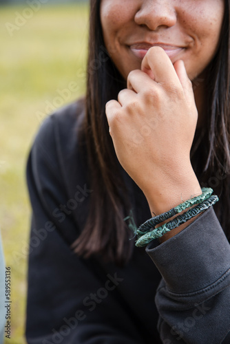 An Aboriginal girl wearing traditional, fibre, woven bracelets photo