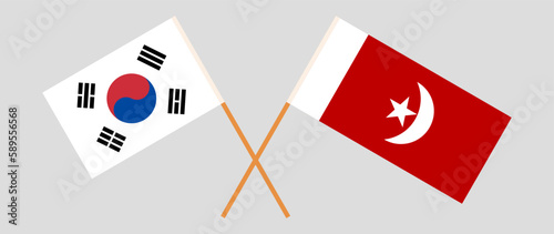 Crossed flags of South Korea and The Emirate of Umm Al Quwain. Official colors. Correct proportion