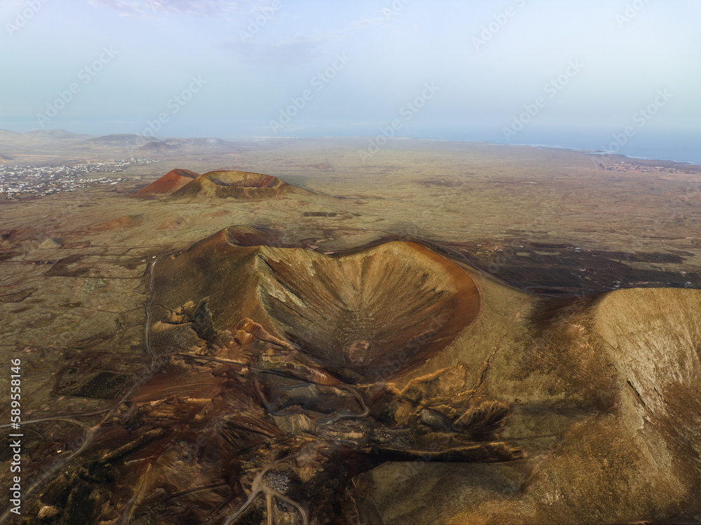 View from above, stunning aerial view of Calderon Hondo during a beautiful sunrise. Calderon Hondo is a volcanic caldera in the sland of Fuerteventura, Canary Islands.