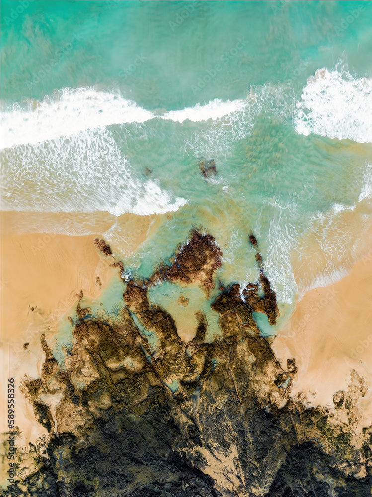 View from above, stunning aerial view of a beautiful beach bathed by a turquoise water. Cofete Beach (Playa de Cofete) Fuerteventura, Canary Islands, Spain.