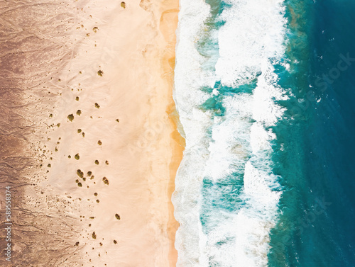 View from above, stunning aerial view of a beautiful beach bathed by a turquoise water. Cofete Beach (Playa de Cofete) Fuerteventura, Canary Islands, Spain.