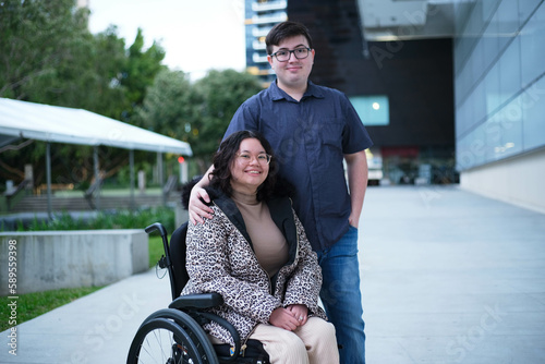 Woman in wheelchair with husband outside photo