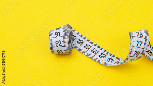 white tape measuring isolated on a yellow background