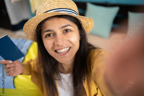 Enjoy traveling. Beautiful woman taking selfie, getting ready for vacation at home, waiting for trip or fly. Millennial making mobile photo of herself, traveling abroad