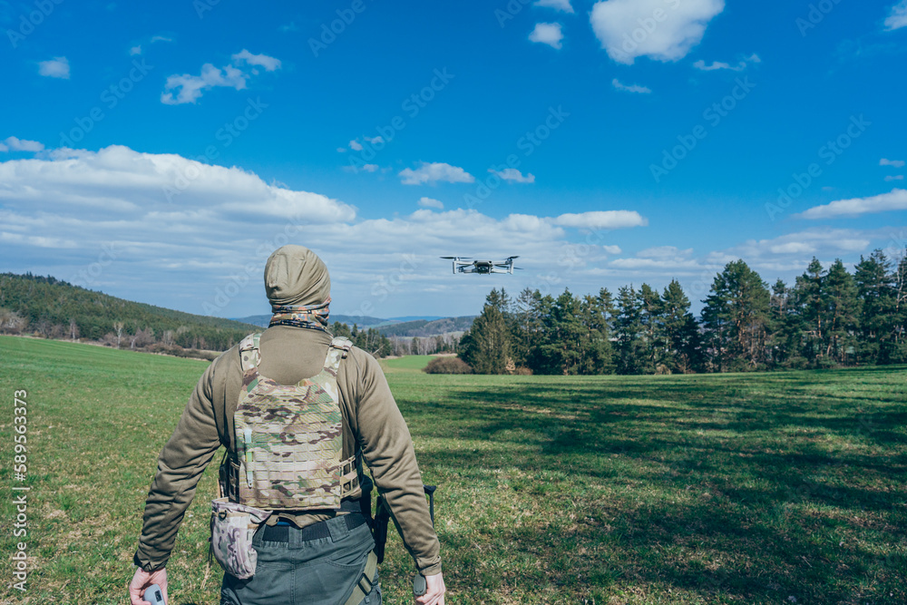 Modern army soldiers using aerial drone for artillery guidance and scouting view enemy positions in military operation. Modern army soldiers using aerial drone for artillery guidance and scouting view enemy positions in military operation.