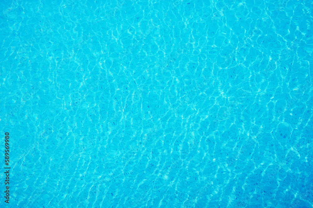 surface of ripple on blue water in swimming pool background.