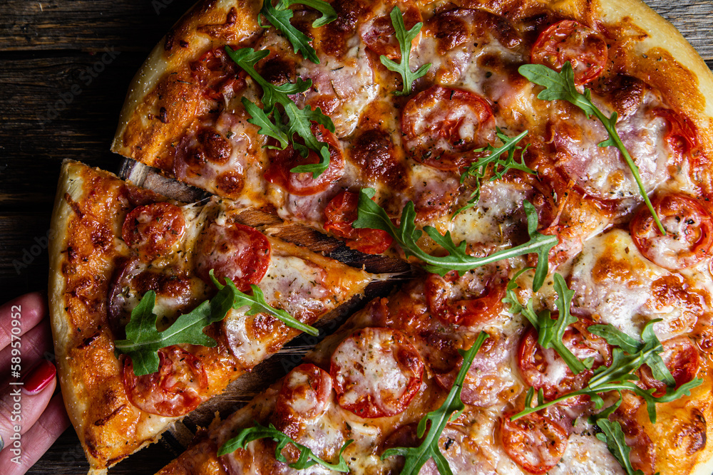 Appetizing pizza with ham on a wooden background Appetizing pizza with ham on a wooden background
