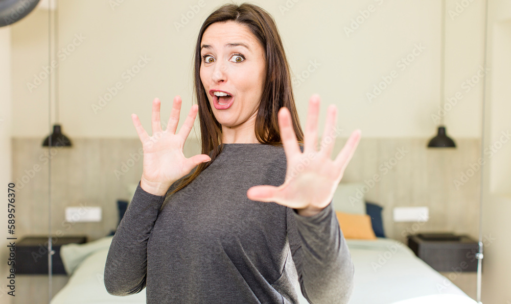 young adult pretty woman feeling terrified, backing off and screaming in horror and panic, reacting to a nightmare young adult pretty woman feeling terrified, backing off and screaming in horror and panic, reacting to a nightmare