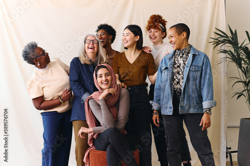 Portrait of cheerful mixed age range multi ethnic women celebrating International Women's Day photo