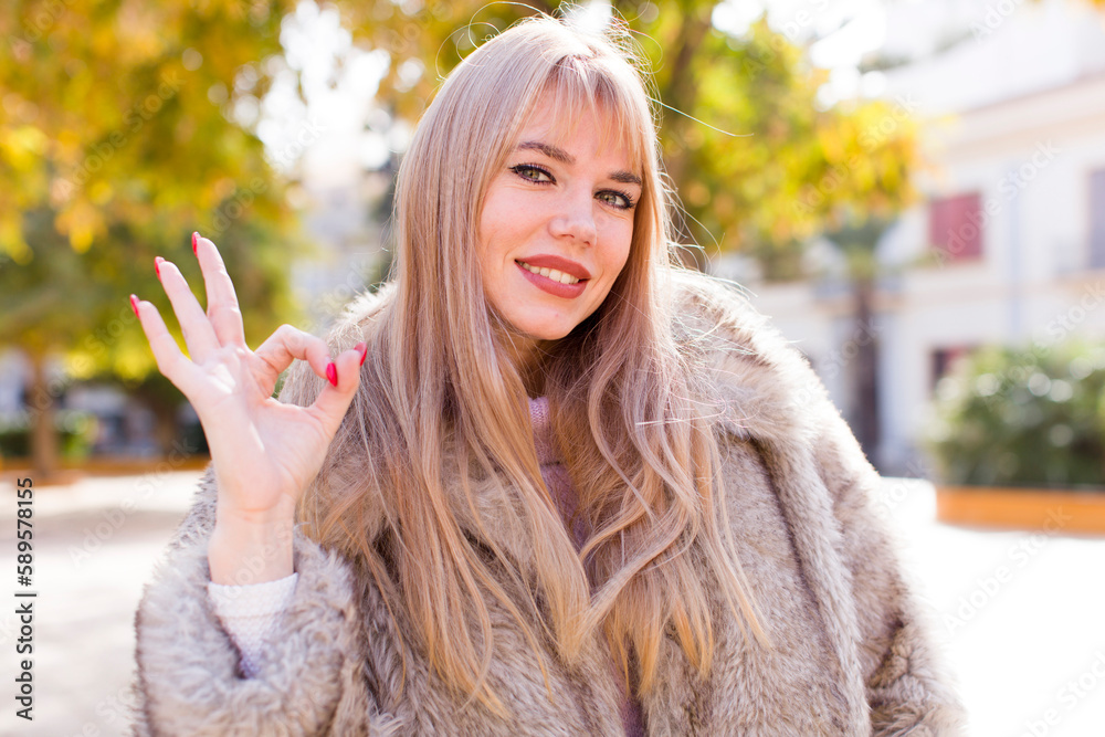 young pretty woman feeling happy, relaxed and satisfied, showing approval with okay gesture, smiling young pretty woman feeling happy, relaxed and satisfied, showing approval with okay gesture, smiling