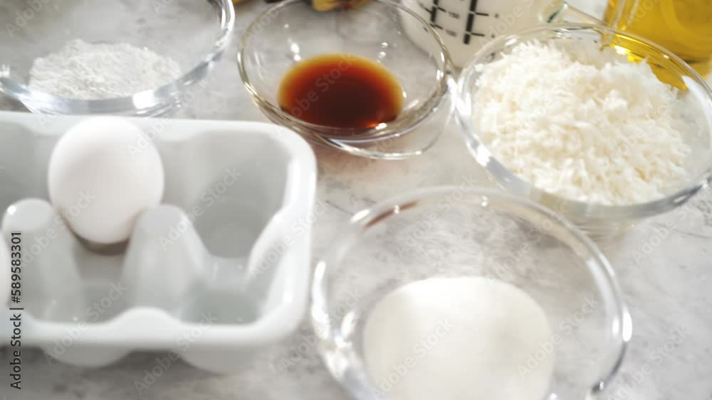 Measured ingredients in glass mixing bowls to prepare coconut banana pancakes for breakfast. Measured ingredients in glass mixing bowls to prepare coconut banana pancakes for breakfast.