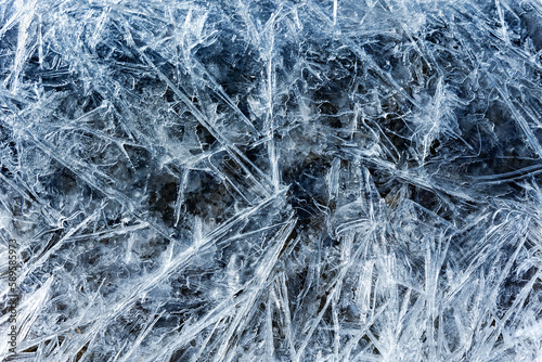 Blue melting ice texture. Texture of ice shards. Winter background. Fragmented ice crystals