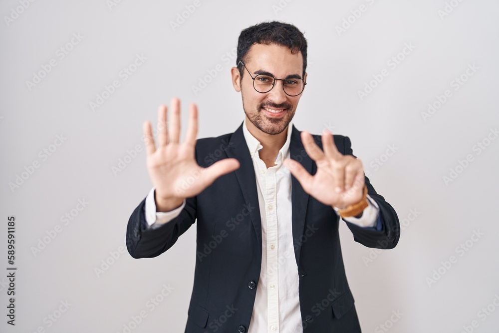 Fototapeta premium Handsome business hispanic man standing over white background showing and pointing up with fingers number eight while smiling confident and happy.