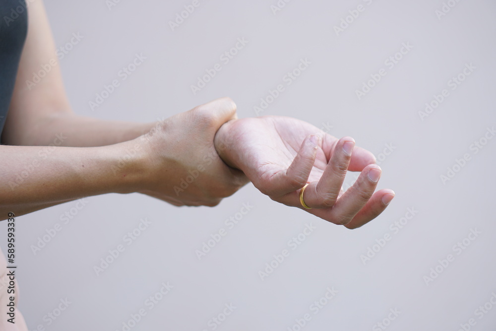 Asian women have muscle weakness and numbness in their arms. Stock