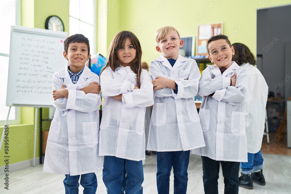 Group of kids scientists students smiling confident standing with arms crossed gesture at laboratory classroom Group of kids scientists students smiling confident standing with arms crossed gesture at laboratory classroom