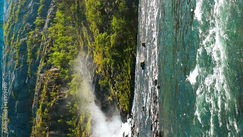 Kinsarvik, Hordaland, Norway. Waterfall Nykkjesoyfossen In Hardangervidda Mountain Plateau. Spring Sunny Day. Height Of 49 m. Vertical Footage Video Famous Norwegian Landmark Destination.  photo