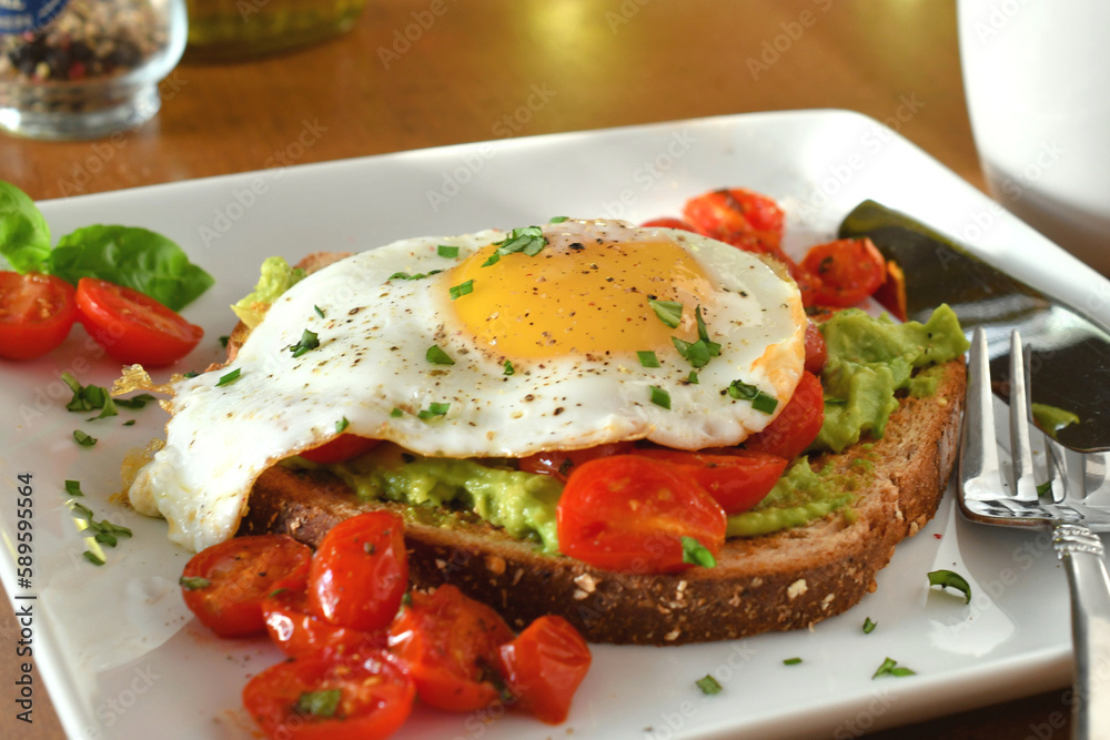 Avocado toast with sunny side up egg and coffee for breakfast, brunch or meal
