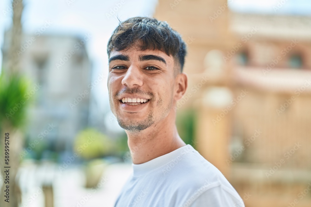 Young hispanic man smiling confident standing at street Young hispanic man smiling confident standing at street