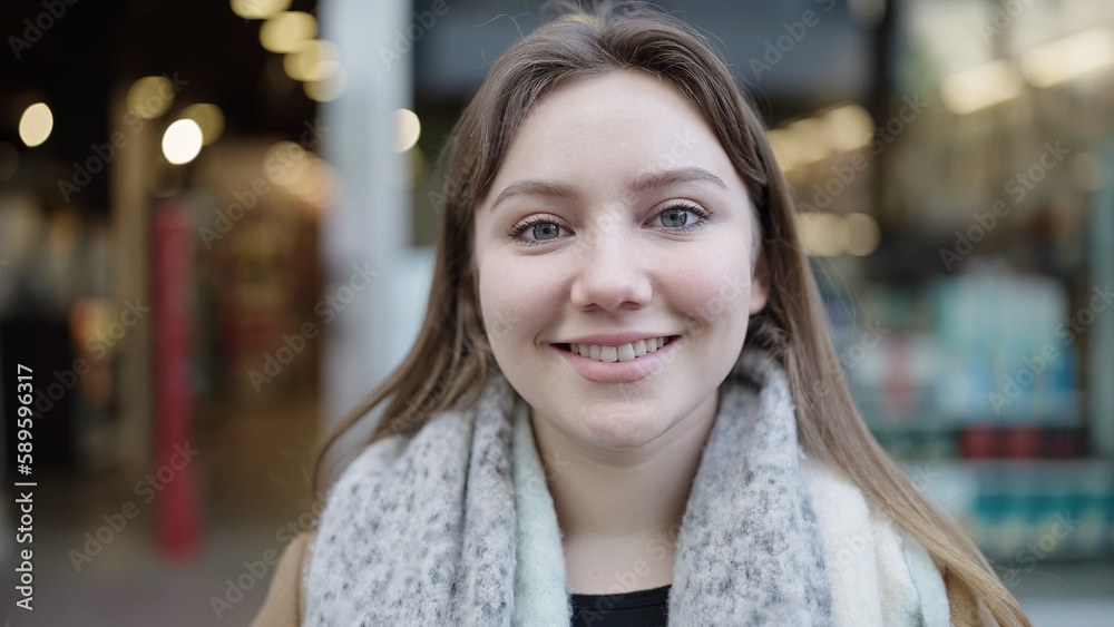 Young blonde woman smiling confident standing at street