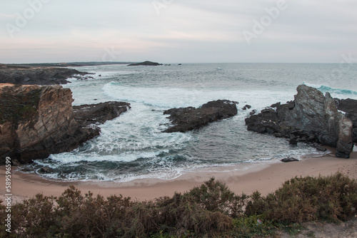 Beauty of the sandy beach of Praia dos Buizinhos with the cliffs at Porto Covo at sunset in western Portugal, at the start of the Rota Vicentina trek