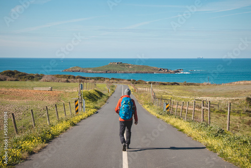 Man full of enthusiasm embarks on his journey along the Fisherman trail - Rota Vicentina along the Atlantic coast of Portugal. Adventurous backpacker hits the road in the spring months
