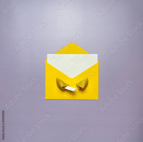 A yellow envelope with a message, a broken fortune cookie on a purple background.