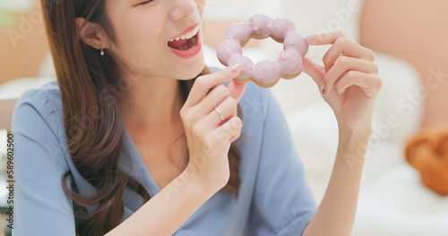 asian woman eating donuts happily