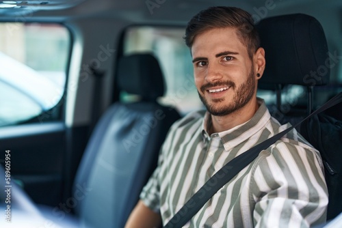 Young caucasian man smiling confident wearing car belt at street