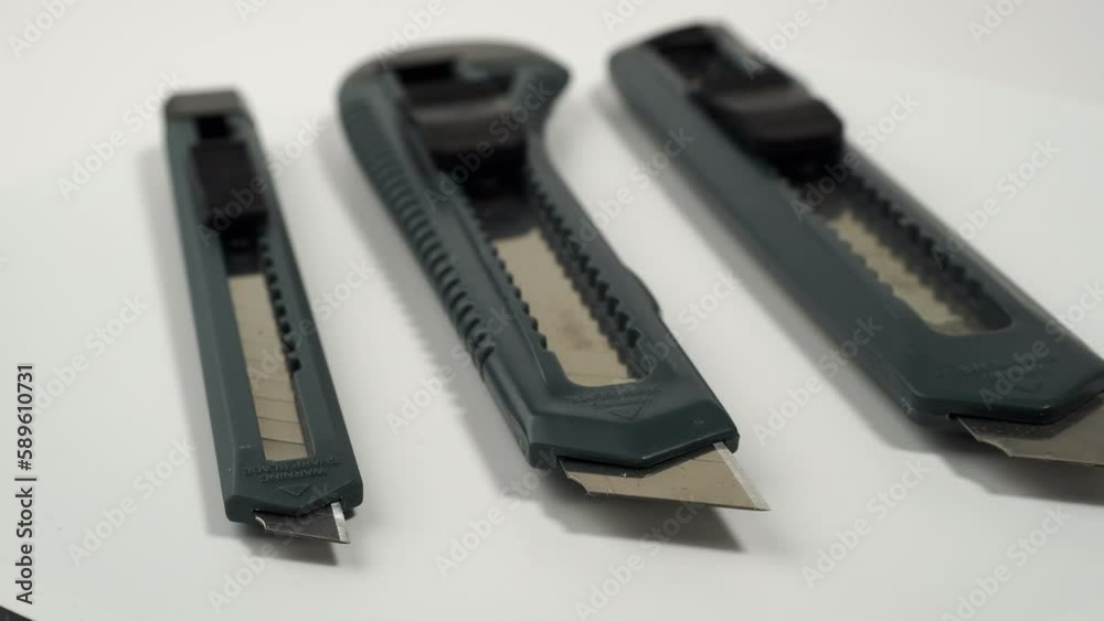 Set of box cutter on a white background. Stationery knife set. Set of box cutter on a white background. Stationery knife set.