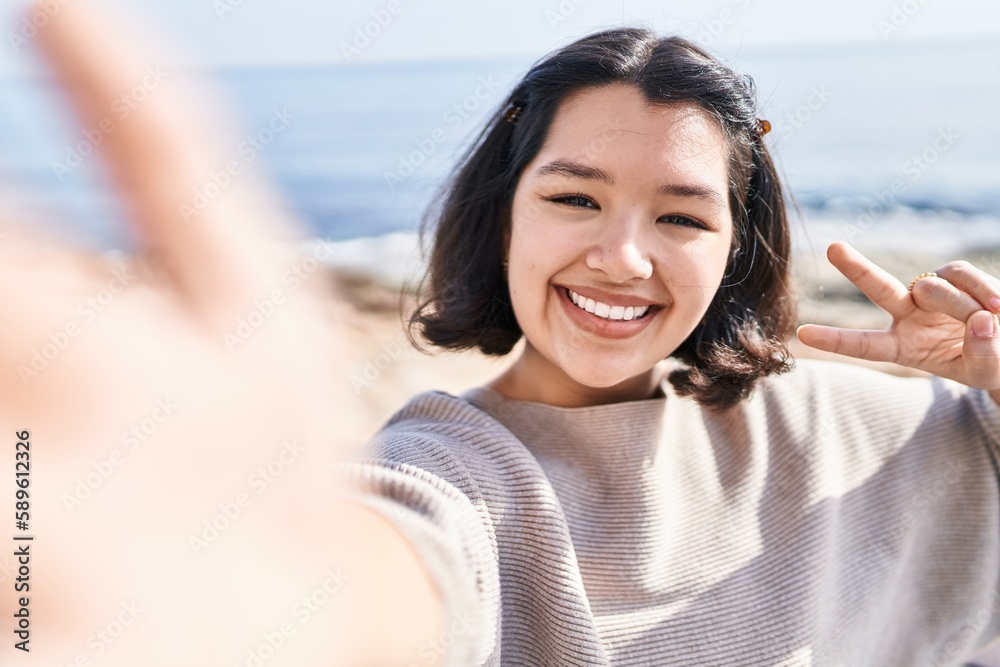Young woman smiling confident making selfie by the camera at seaside Young woman smiling confident making selfie by the camera at seaside