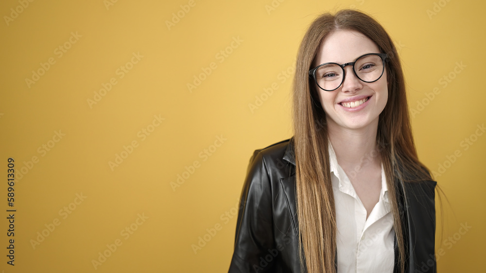 Young blonde woman smiling confident standing over isolated yellow background