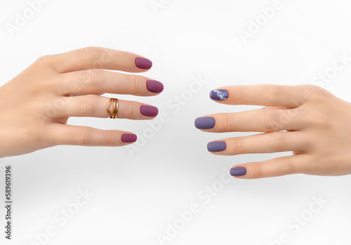 Beautiful purple burgundy matte manicure on white background
