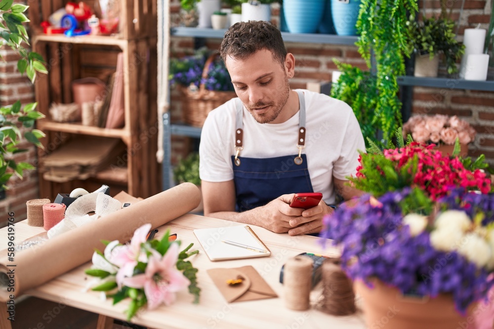 Young hispanic man florist using smartphone at florist Young hispanic man florist using smartphone at florist
